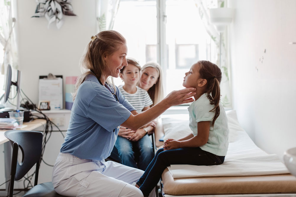 A nurse examines a child